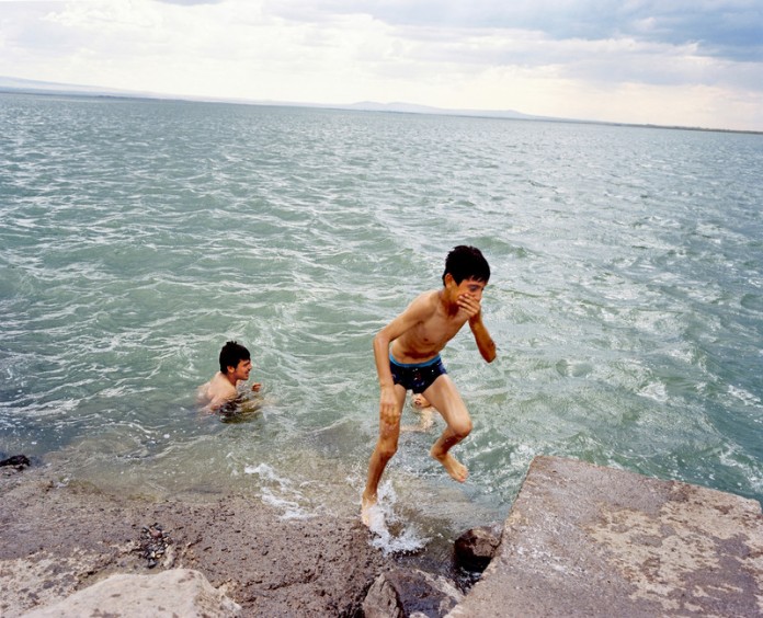 Kids playing in the Devegeçidi reservoir dam. The Dam is one of the 22 dams of the Southeastern Anatolia Project of Turkey. It is near Diyarbak?r on a branch of the Tigris river. Turkey